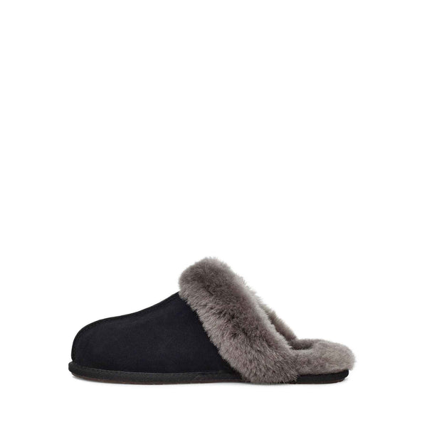 Side view of a single black UGG slipper with fluffy lining on a white background.