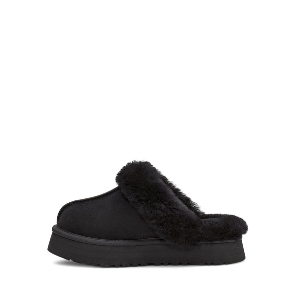 Black fluffy slipper with brand logo on a white background.