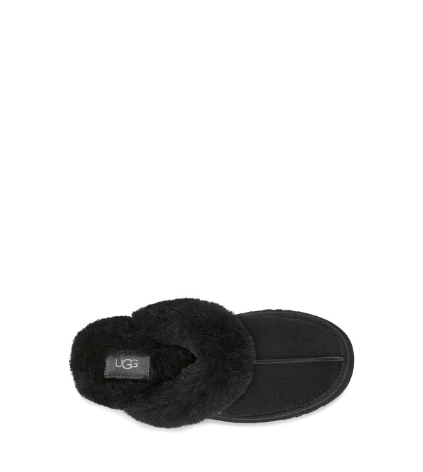 Black fluffy slipper with brand logo on a white background.