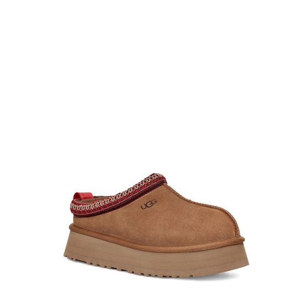 Brown suede slip-on shoe with red stitching and thick rubber sole.