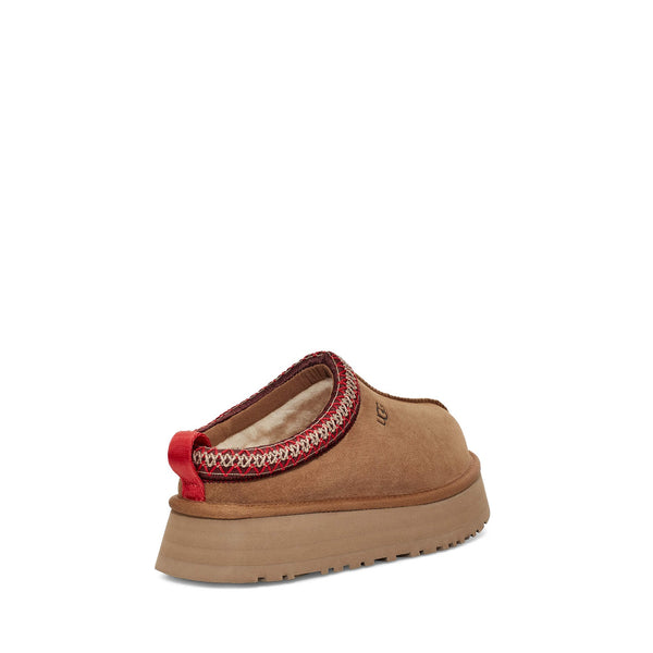 Brown suede slip-on shoe with red stitching and thick rubber sole.