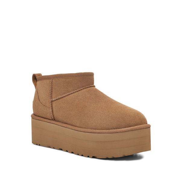 Tan ankle boot with a platform sole on a white background.