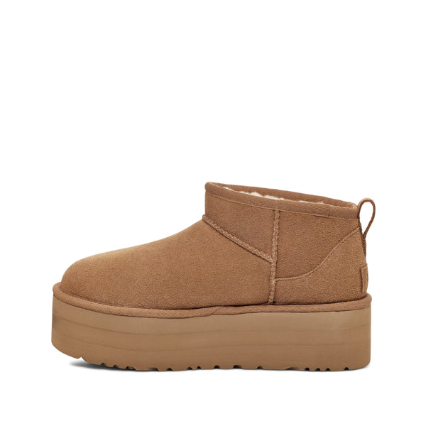 Tan ankle boot with a platform sole on a white background.