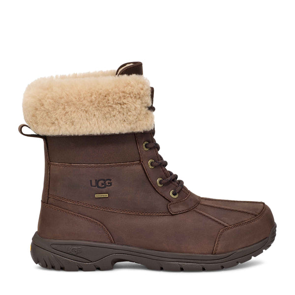 Side view of a brown UGG winter boot with fleece cuff.