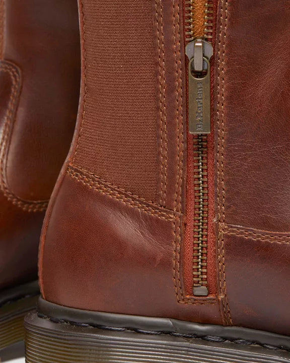 Close-up of a brown leather boot with a side zipper and stitching details.