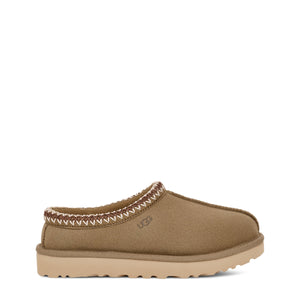 Tan slip-on shoe with zigzag stitching and a branded label on a white background.