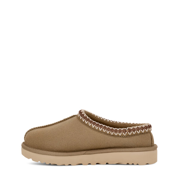 Tan slip-on shoe with zigzag stitching and a branded label on a white background.