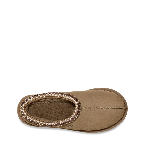 Tan slip-on shoe with zigzag stitching and a branded label on a white background.