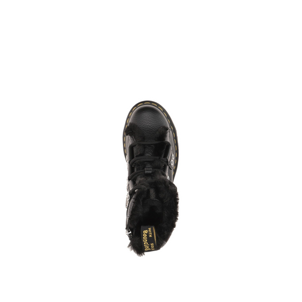 Black leather boot with fur lining and yellow stitching on a white background. Top view.