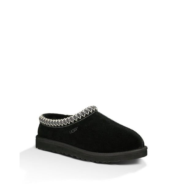 Black UGG slipper with braided trim detail on a white background.