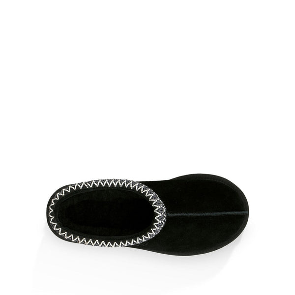 Black UGG slipper with braided trim detail on a white background.