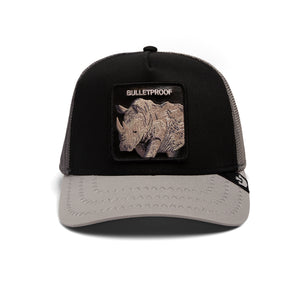 A black and gray trucker cap with a rhinoceros patch labeled 